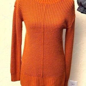 Rust colored knit sweater.